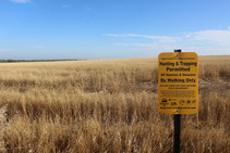 Land with Open Fields and Waters sign