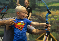 Boy practicing on archery range at state fair exhibit