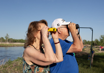 Senior couple looking for birds through binoculars