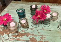 Small candles with artificial flowers