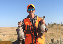 Upland hunter posing with birds