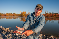 Angler holding a fish in autumn