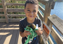 Young boy holding a fish