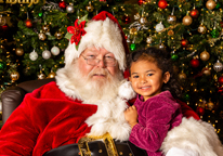 Girl with Santa at Mahoney's Classic Christmas event