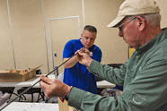 Instructor helping student build a fly rod