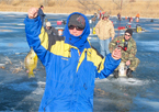 Participant holding up a fish at an ice fishing clinic