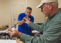 Instructor helping a student build a fly rod