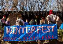 People gathered by a Winterfest banner at Ponca State Park