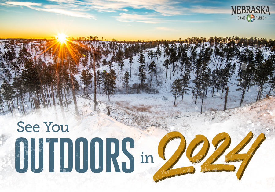 Sunrise over western Nebraska snowy bluffs with text, "See you outdoors in 2024"