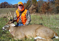 Hunter posing with harvested deer