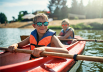 Kids kayaking on a sunny day