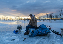 Angler fishing through the ice