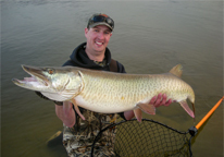 Angler holding a master angler muskie. Photo by Daryl Bauer.