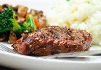 Steak dinner with mashed potatoes and vegetables