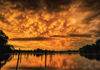 Striking gold-orange skies reflecting over a lake