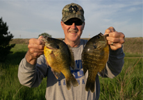 Man holding a master-angler sized bluegill he caught