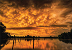 Winning image from photo contest, showing a dramatic orange sky over a lake