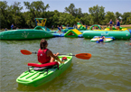 Lifeguard kayaking at floating playground