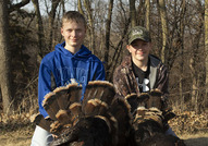 Youth hunters posing with turkeys they harvested
