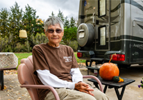 Helen Brazee sitting by her camper