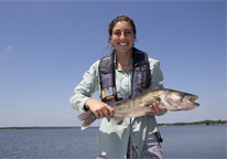 Female angler holding up a walleye