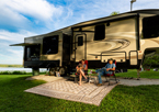 Campers relaxing by their RV at Summit Lake State Recreation Area.