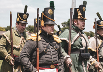 Living history reenactors, portraying soldiers, marching at Fort Atkinson