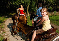 Girl smiling as she rides a horse at Mahoney State Park