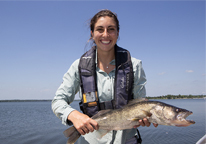 Female angler holding up a large walleye at Branched Oak Lake