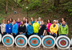 Group of women standing behind a row of archery targets at a state park