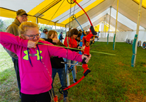 Girl practicing archery at the Fort Kearny Expo