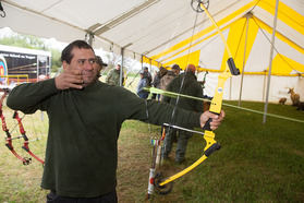 Man practicing archery at the Fort Kearny Expo
