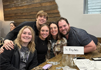 Group of friends posing and smiling at a Nebraska Nature Nerd trivia night