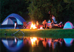 A family's campsite around a campfire at a state park