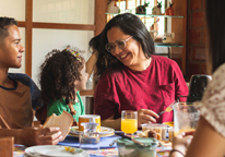 Grandma smiling with her family at a meal together