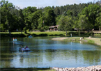 People paddle boating on a pond at Chadron State Park