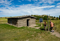 Visitors walking up to a replica sod house at Ash Hollow State Historical Park