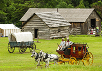 Historical buildings and a horse-dragon wagon at Rock Creek Station State Historical Park