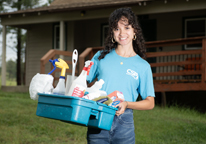 Housekeeper holding cleaning supplies