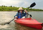 A woman kayaking on a river