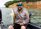 Angler at Lewis and Clark Lake holding up a walleye