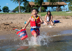 Boy playing in the water with a lifejacket at Branched Oak State Recreation Area