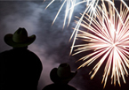 Silhouettes of people watching fireworks