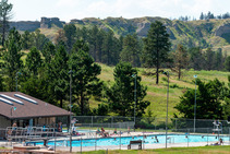 The outdoor pool at Chadron State Park with buttes in background