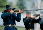 Reenactors firing old-fashioned rifles at Fort Hartsuff