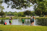 People fishing at a lake during a Community Fishing night