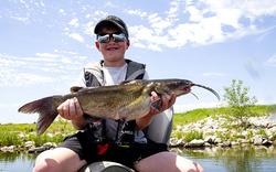 Boy holding a channel catfish he caught at Flanagan Lake in Douglas County