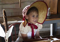 Child dressed in period clothing at Fort Atkinson State Historical Park during a living history event