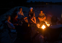 People gathered around a campfire at Wagon Train Lake