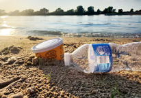 Closeup view of trash laying on a beach